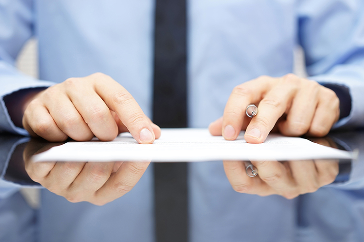 businessman is carefully reading contract